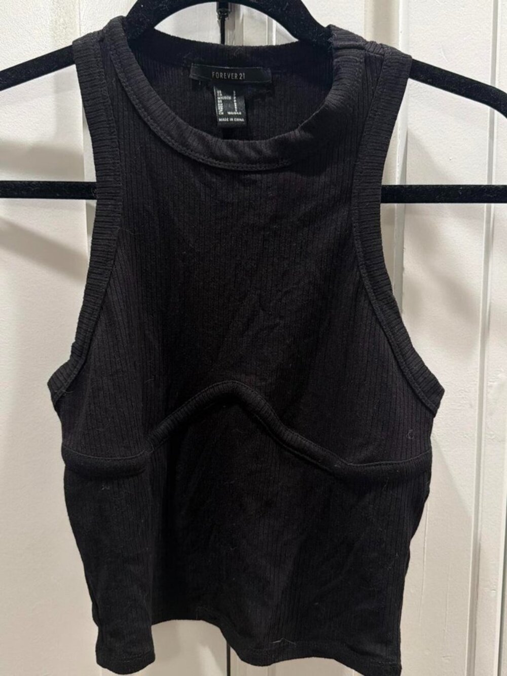 Black ribbed tank top with a unique cutout design